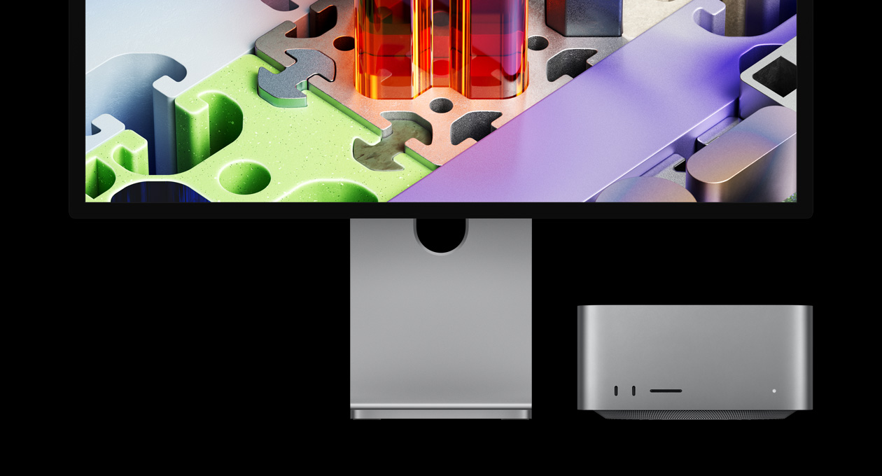 Studio Display XDRと組み合わせたMac Studio。デバイスはスクリーンの下に収納されている。Studio Display XDRには、3Dのパズルのような壁紙が表示されている